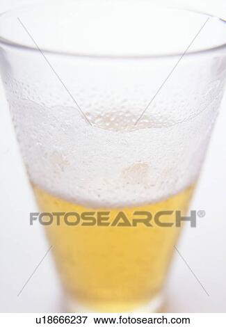 Stock Photo - Glass of beer, close up, white background. Fotosearch