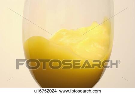 Picture - Glass of orange juice, close up, colored background. Fotosearch