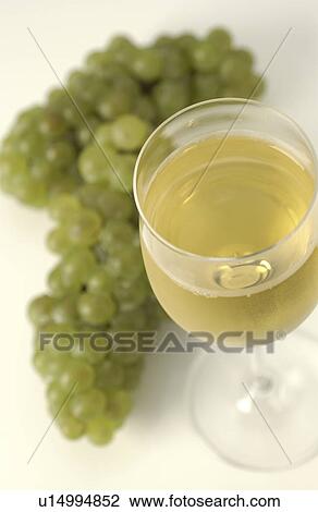 Glass of White Wine and Green Grapes View Large Photo Image Stock Image - Glass of White Wine and Green Grapes. Fotosearch