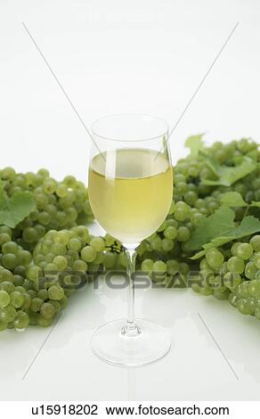 Glass of White Wine and Green Grapes View Large Photo Image Stock Image - Glass of White Wine and Green Grapes. Fotosearch