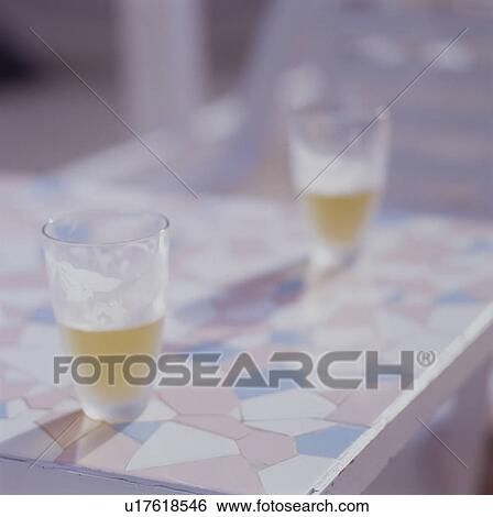 Glasses of beer on table View Large Photo Image Stock Photograph - Glasses of beer on table. Fotosearch