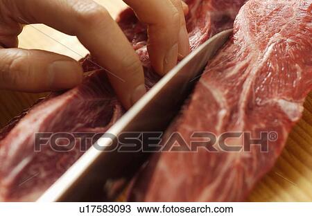 Hand cutting meat View Large Photo Image Stock Image - Hand cutting meat. Fotosearch