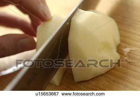 Stock Photo - Hand cutting potato. Fotosearch