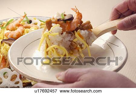 Hand serving Gomoku Chirashi-zushi View Large Photo Image Stock Photo - Hand serving Gomoku Chirashi-zushi. Fotosearch