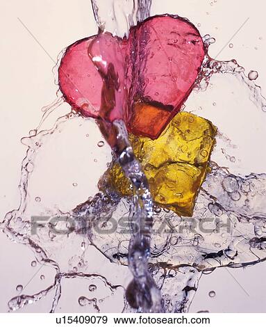 Heart shaped and square objects being washed View Large Photo Image Stock Photo - Heart shaped and square objects being washed. Fotosearch