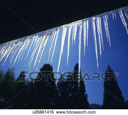 Stock Photograph - Icicles hanging from roof. Fotosearch