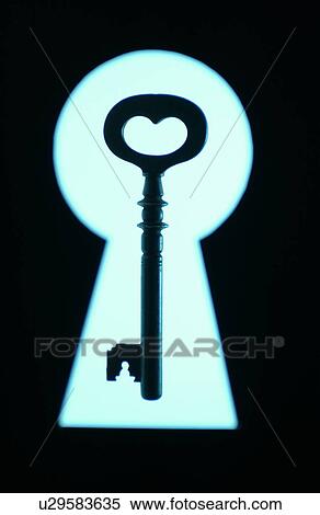 Stock Photography - Key in frame of keyhole, black background. Fotosearch