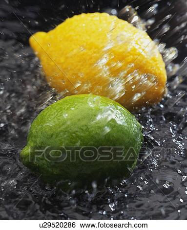 Stock Photograph - Lime and lemon, close up, blurred motion. Fotosearch