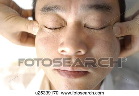 Man getting Shiatsu on his face View Large Photo Image Stock Image - Man getting Shiatsu on his face. Fotosearch