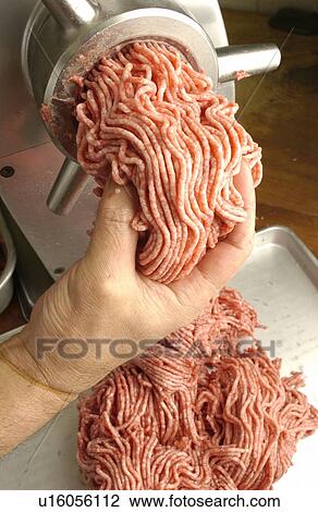 Man grinding meat, close up View Large Photo Image Stock Image - Man grinding meat, close up. Fotosearch