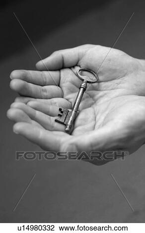 Man holding a key, black and white View Large Photo Image Stock Image - Man holding a key, black and white. Fotosearch