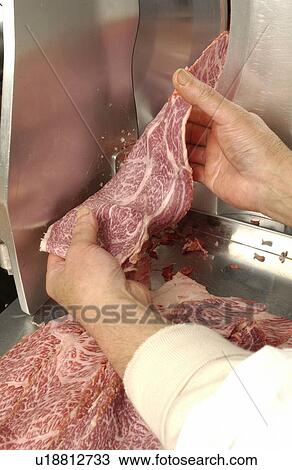 Man using meat slicer, holding a slice of meat View Large Photo Image Stock Image - Man using meat slicer, holding a slice of meat. Fotosearch