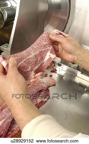 Man using meat slicer, holding a slice of meat View Large Photo Image Stock Image - Man using meat slicer, holding a slice of meat. Fotosearch