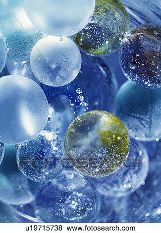 Stock Photo - Marbles in water. Fotosearch