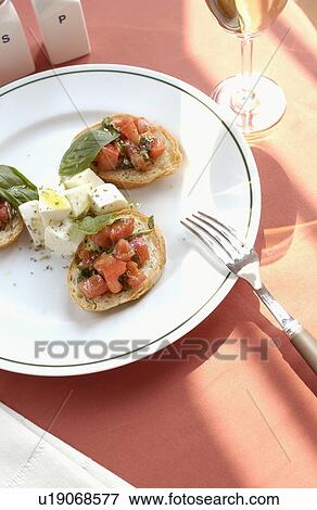 Mozzarella cheese and tomato on bruschetta and white wine View Large Photo Image Stock Photo - Mozzarella cheese and tomato on bruschetta and white wine. Fotosearch