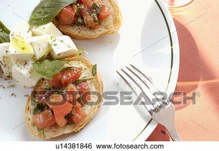 Mozzarella cheese and tomato on bruschetta View Large Photo Image Stock Photograph - Mozzarella cheese and tomato on bruschetta. Fotosearch