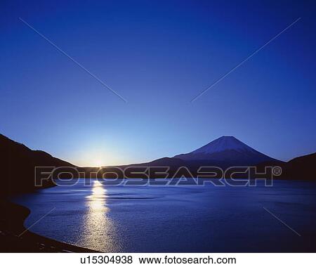 Stock Photo - Mt. Fuji from Lake Motosuko, lens flare, Minobu town, Yamanashi prefecture, Japan. Fotosearch
