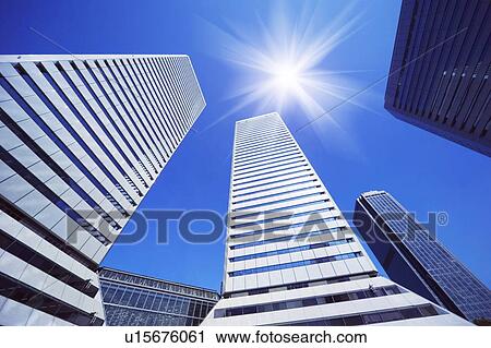 Office buildings under the blue sky, lens flare, Osaka city, Osaka prefecture, Japan View Large Photo Image Stock Image - Office buildings under the blue sky, lens flare, Osaka city, Osaka prefecture, Japan. Fotosearch