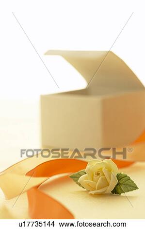Picture - Opened gift box and rose, white background. Fotosearch