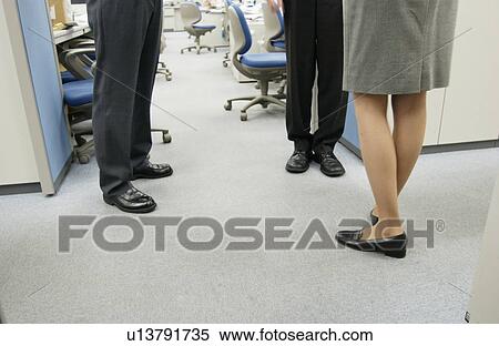 Stock Photography - People Standing in Office. Fotosearch