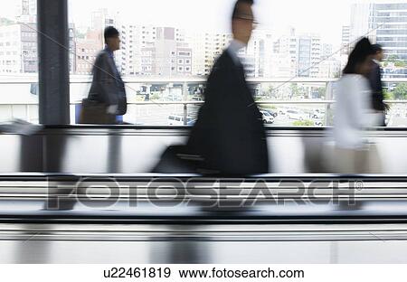 People walking down the passage, blurred motion View Large Photo Image Stock Photo - People walking down the passage, blurred motion. Fotosearch
