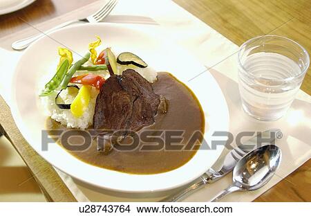 Picture - Plate of curry and rice. Fotosearch