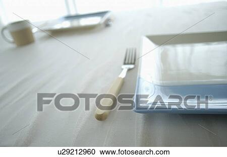Plates and fork on table, close up View Large Photo Image Stock Image - Plates and fork on table, close up. Fotosearch