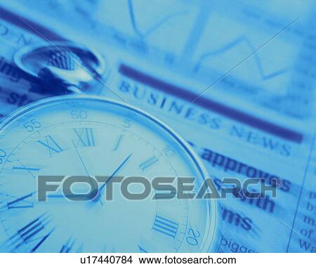 Picture - Pocket watch on newspaper, close up, toned image, blurred motion. Fotosearch