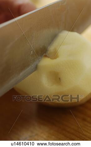 Stock Image - Potato being cut. Fotosearch