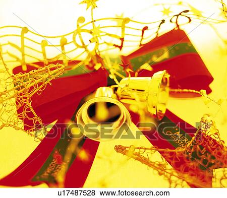 Stock Photo - Ribbon with Christmas bells, close up. Fotosearch