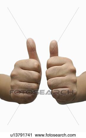 Stock Image - Shiatsu masseuse with his thumbs up. Fotosearch