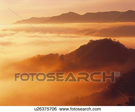 Silhouette of mountain ranges in clouds, sepia toned, Takachiho town, Miyazaki prefecture, Japan View Large Photo Image Stock Photograph - Silhouette of mountain ranges in clouds, sepia toned, Takachiho town, Miyazaki prefecture, Japan. Fotosearch