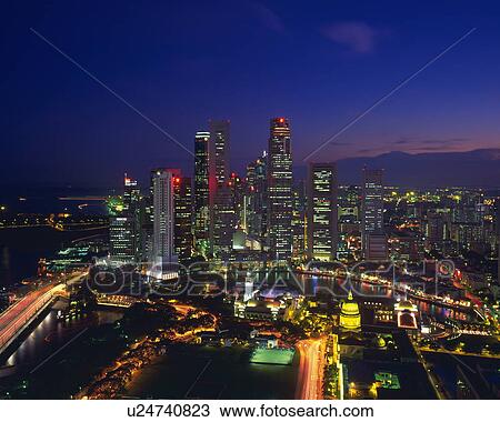 Stock Image - Singapore skyline at night. Fotosearch