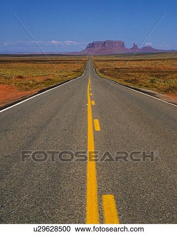 Stock Image - Single Road Toward to Monument Valley. Fotosearch