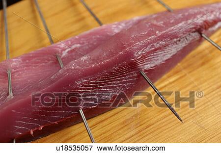 Stock Photo - Skewered sliced bonito, close up. Fotosearch