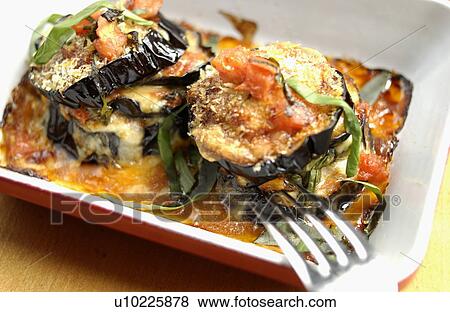 Stock Photo - Slices of eggplant cooked with cheese. Fotosearch