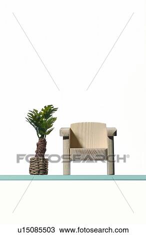 Stock Image - Small chair and plant. Fotosearch