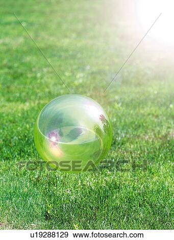 Stock Photo - Soap bubble over lawn, computer graphic, Yokohama city, Kanagawa prefecture, Japan. Fotosearch
