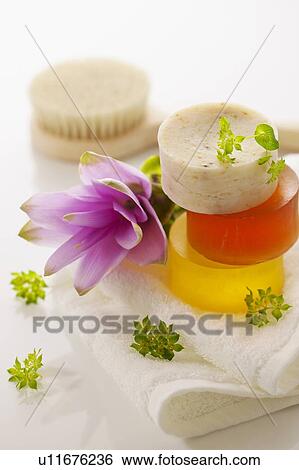Stock Photograph - Soaps on towel, white background. Fotosearch