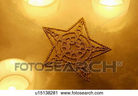 Stock Image - Star decoration and candles. Fotosearch