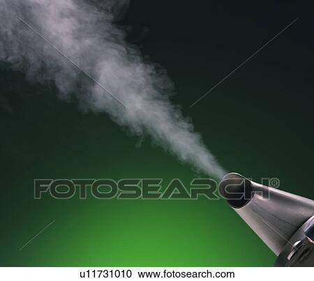 Stock Image - Steam coming out of kettle, green background. Fotosearch