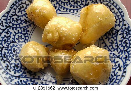 Stock Image - Sugared fried banana on plate. Fotosearch