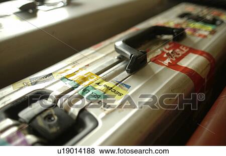 Stock Photo - Suitcase with travel stickers, close up. Fotosearch
