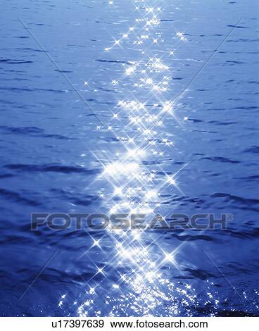 Stock Photo - Sunlight reflection on rippled water, full frame. Fotosearch