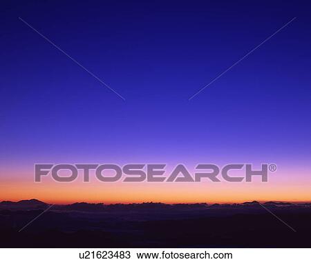 Stock Image - Sunrise over clouds. Fotosearch