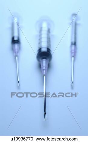 Stock Image - Three syringes with needles. Fotosearch