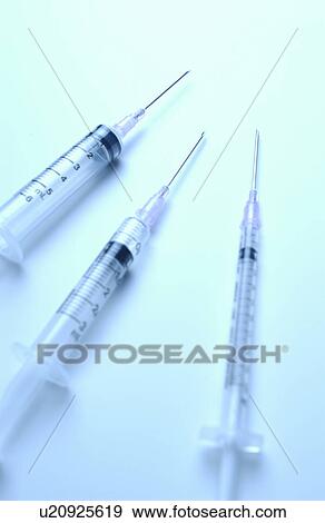 Stock Photo - Three syringes with needles. Fotosearch