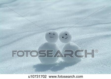 Two snowmen on snowy land View Large Photo Image Stock Image - Two snowmen on snowy land. Fotosearch