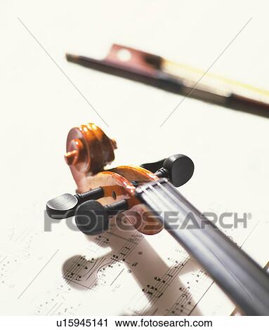 Stock Image - Violin on sheet music, close up. Fotosearch