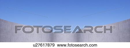 Stock Photo - Wall against blue sky, copy space. Fotosearch